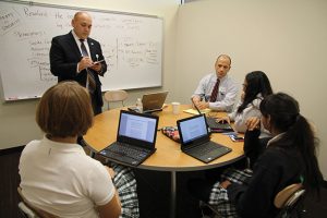 IN OUR SHOES Upper School Head John Ashton attends one of Assistant Director of Debate and Forensic Activities Jason Sykes’ debate classes. Photo by Emily Yeh