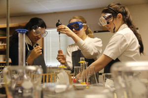 BETTER SAFE THAN SORRY  Seniors Shivani Sharma, Katherine Magee and junior Holly Haley don safety goggles in an Organic Chemistry class to ensure lab safety. Photo by Mary Clare Beytagh