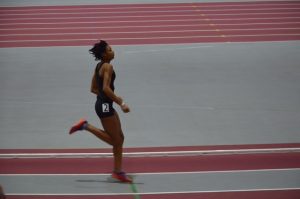 Coutee-McCullum crosses the finish line in a 200 meter dash.