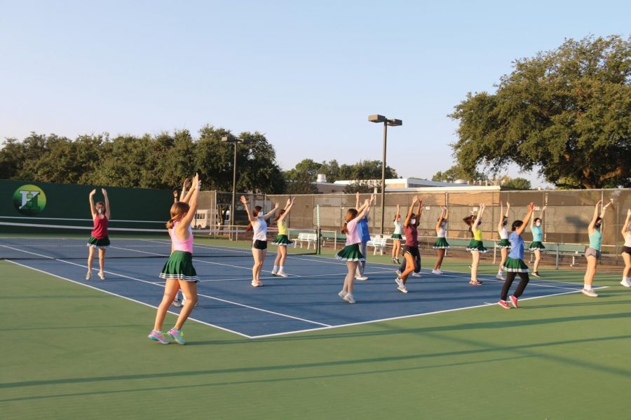 The+drill+team+practices+on+the+tennis+courts+in+the+morning%2C+spread+out+to+maintain+social+distancing.+photo+by+Annie+Herring.