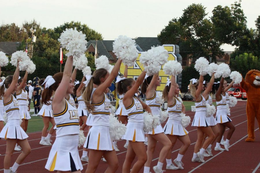 Cheerleaders+hype+up+the+crowd+before+a+play+at+the+first+home+game+of+the+year.%0A