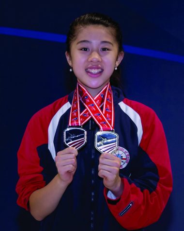 Liu poses with her medals after placing in national fencing events.