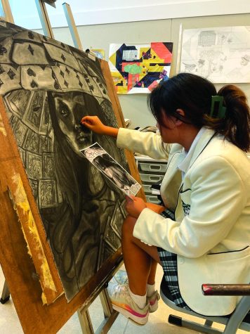 Senior Catherine Choi works on a self portrait in preparation for ISAS