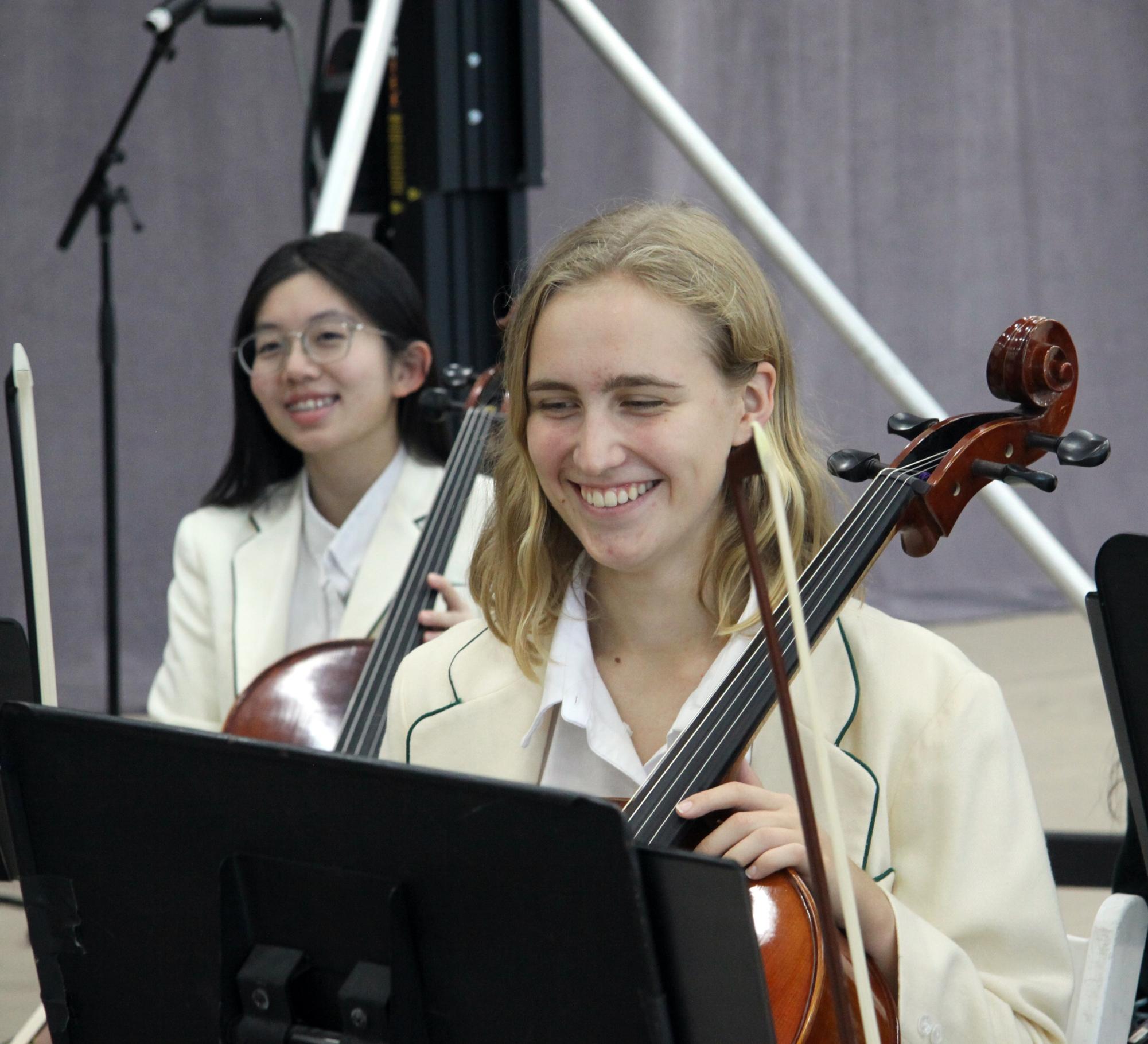 Senior orchestra performers beam after a successful performance at Augusts convocation ceremony.