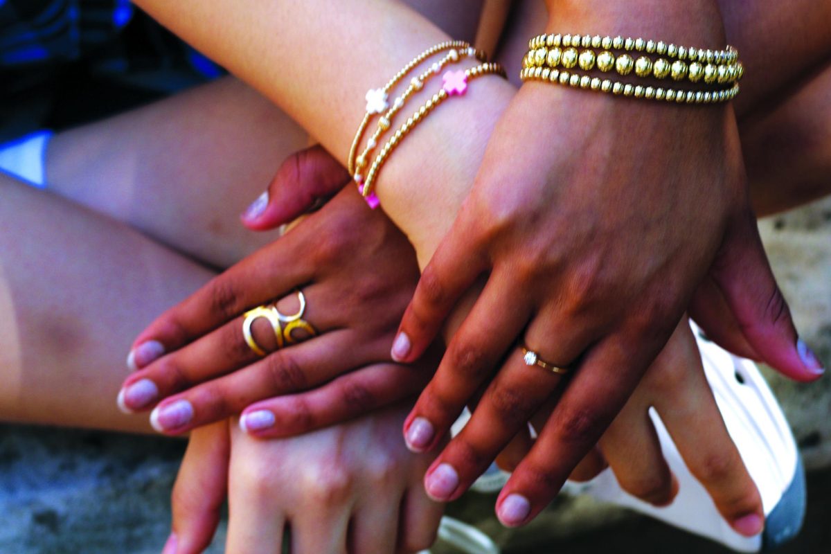 Sophormores Betty Liu and Sanjana Rajagopalan show off the jewelry they wear.