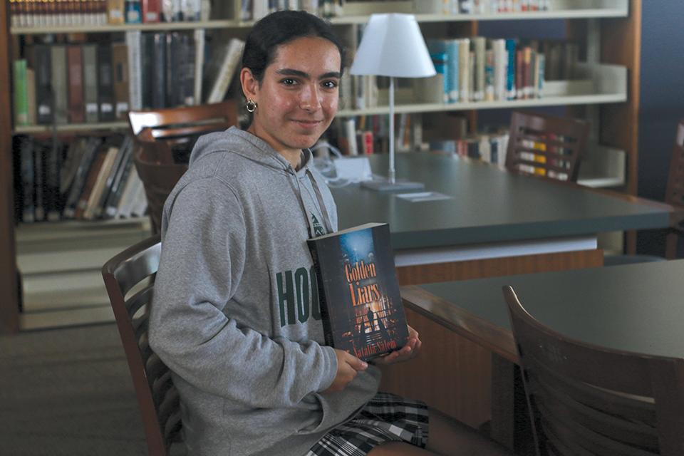 Salem poses with her book "Golden Liars"