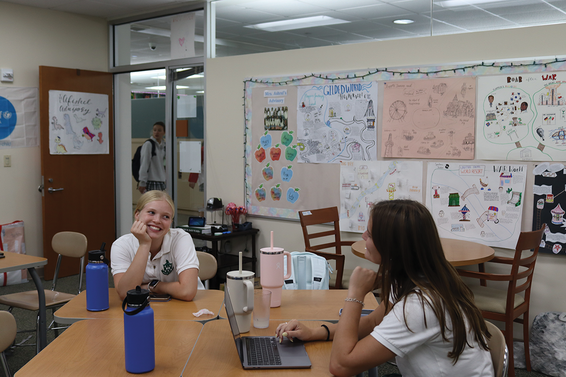 Juniors Callie Coats and Kate McAtee talk to each other about their summers during Back-to-School Day. “My favorite part was the movie discussions because we got to talk with people from other grades and get to reconnect with my friends,” Coats said. 

 