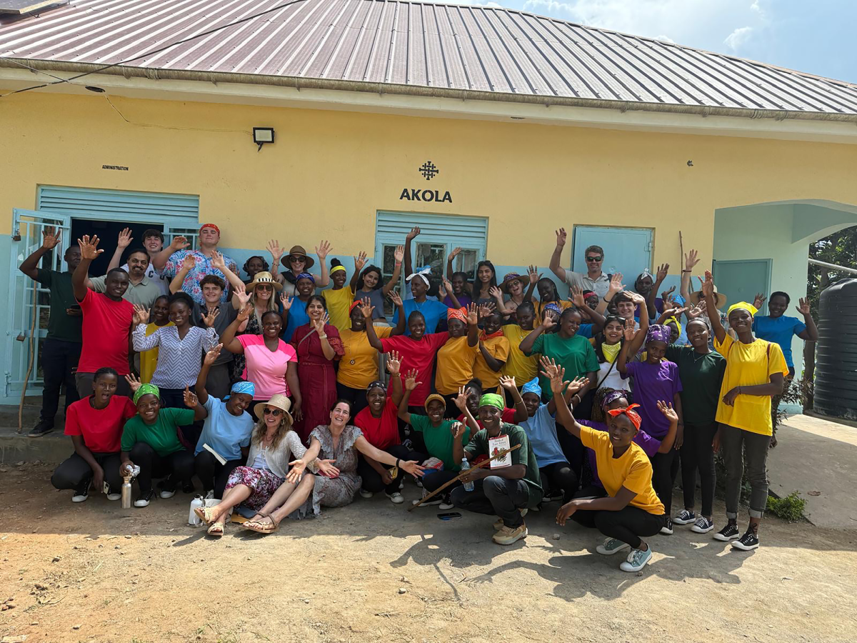 Menon, Guttigoli and their families pose with the AWWI community.