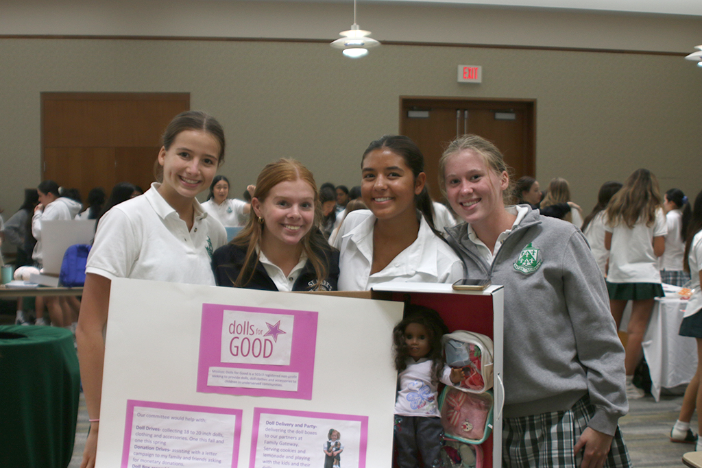 Flanagan and Buckner advertise Dolls for Good at the club fair.