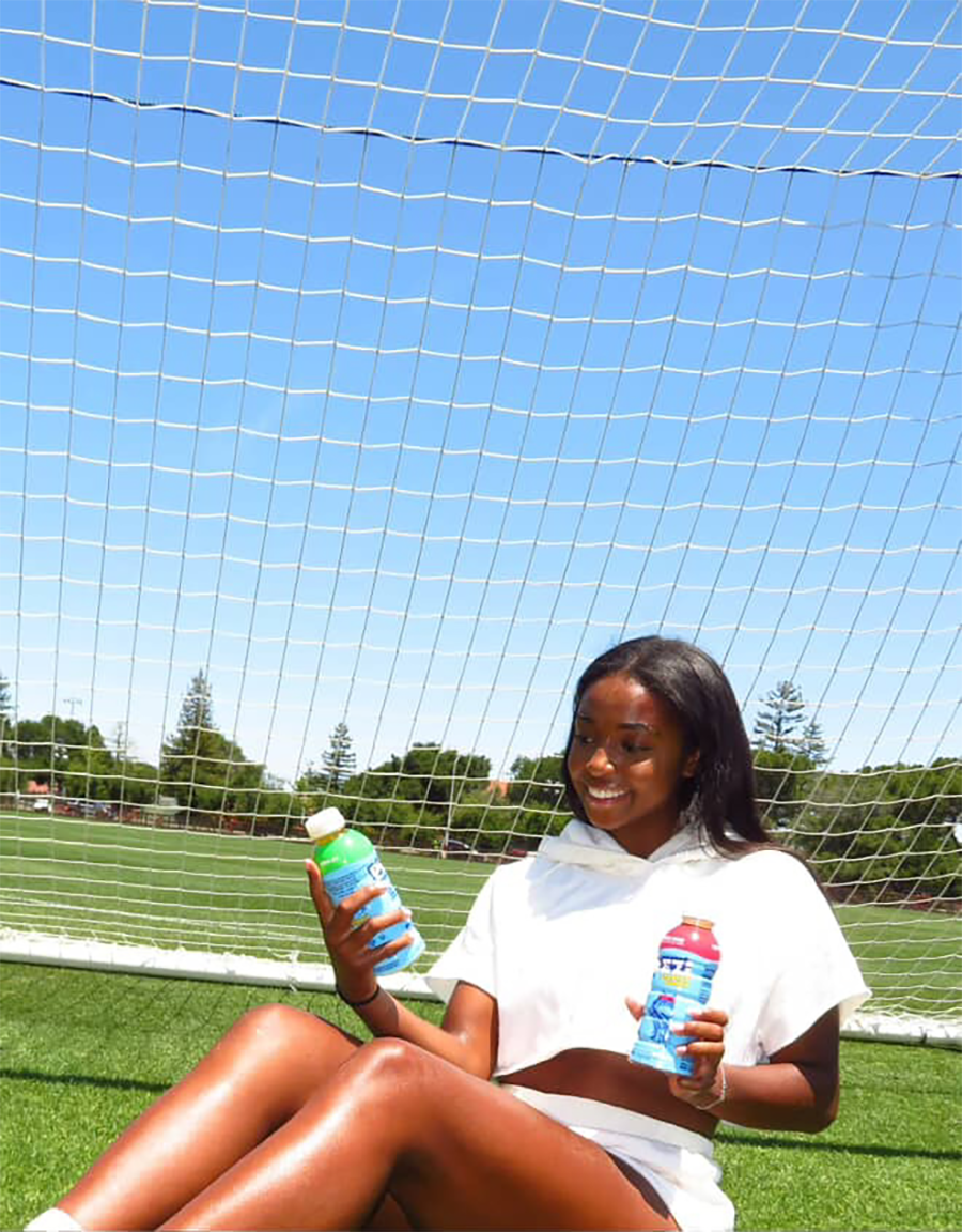 Thomas poses with Plezi hydration drinks to market her partnership