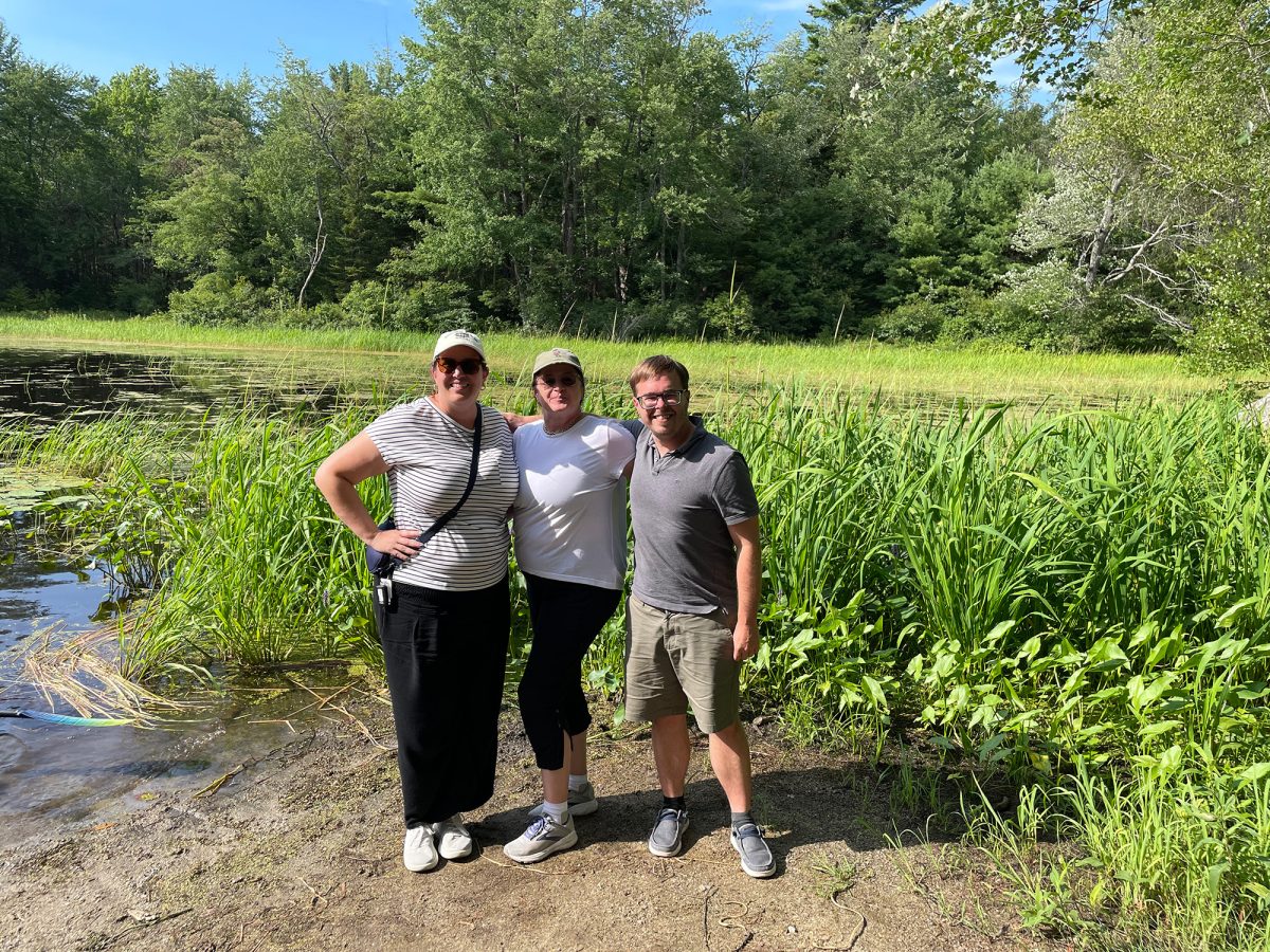 Boulanger, Lummus and friend in front of Runaround Pond in Durham, Maine during their writing retreat