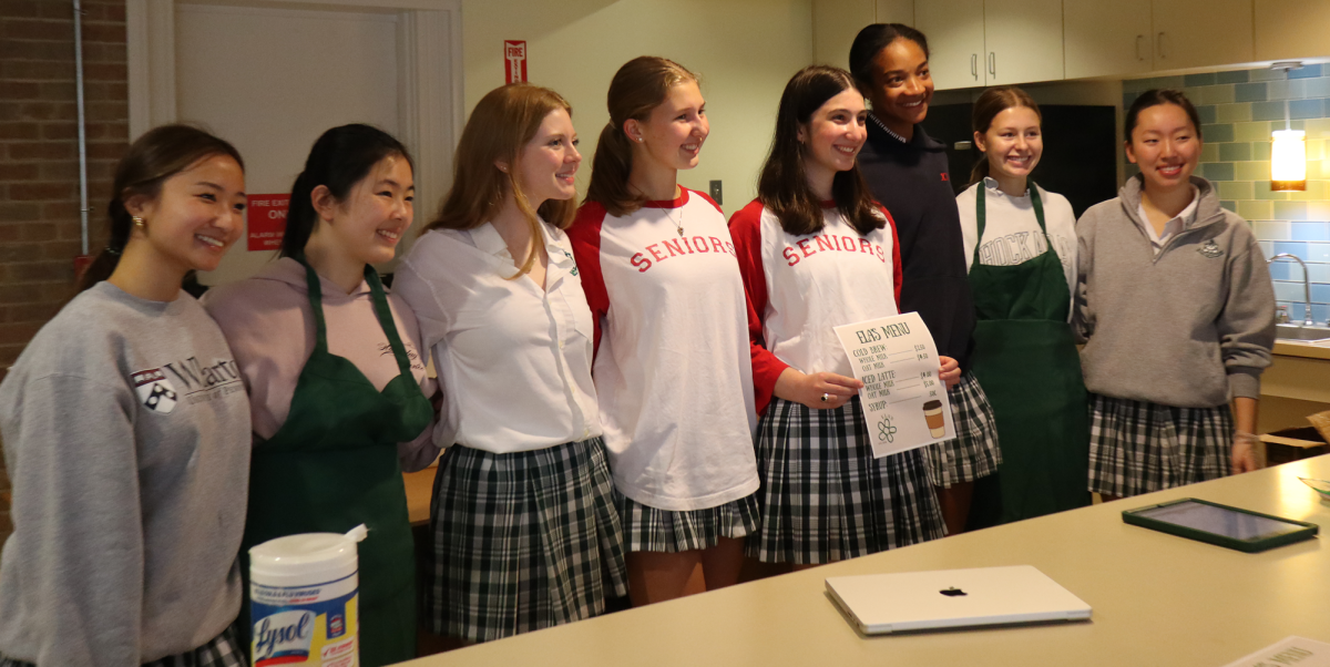The Ela's team poses with a menu.